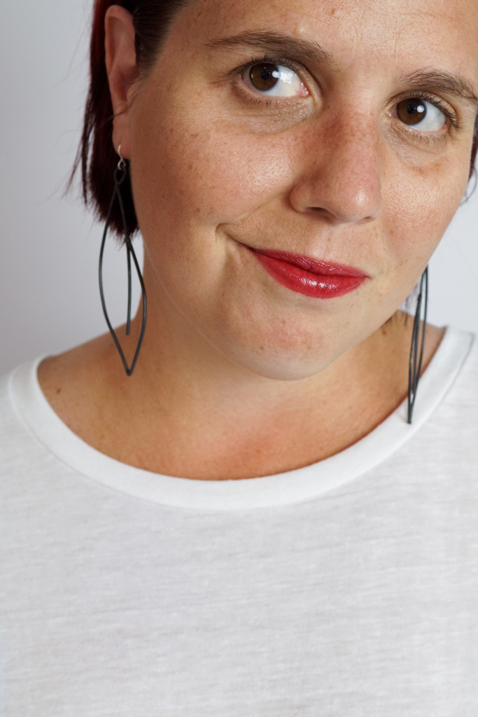 black statement earrings with white t-shirt and red lipstick