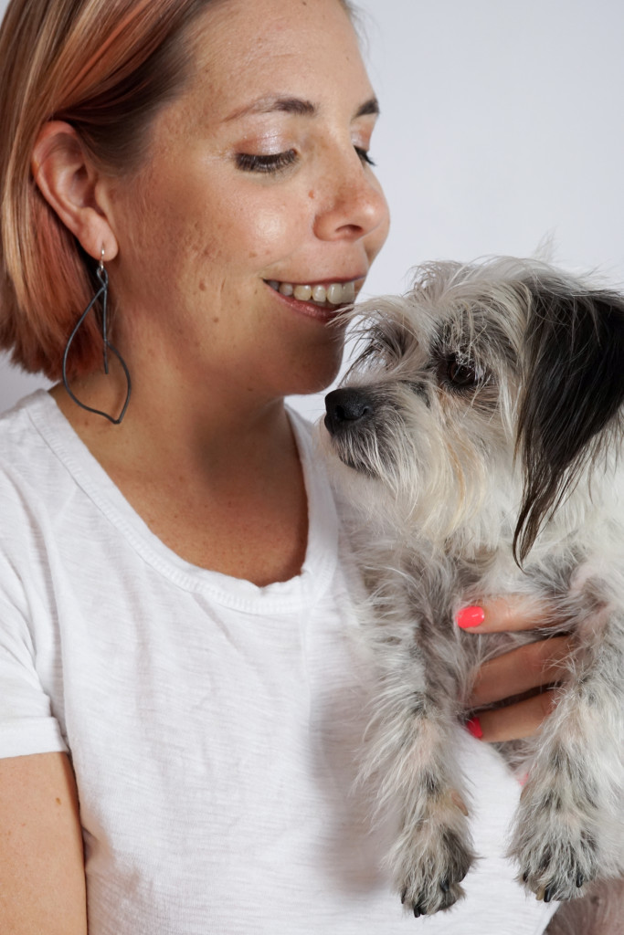 black statement earrings with white t-shirt and black and white dog