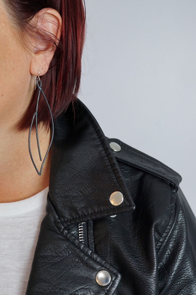 black statement earrings with leather jacket and white t-shirt