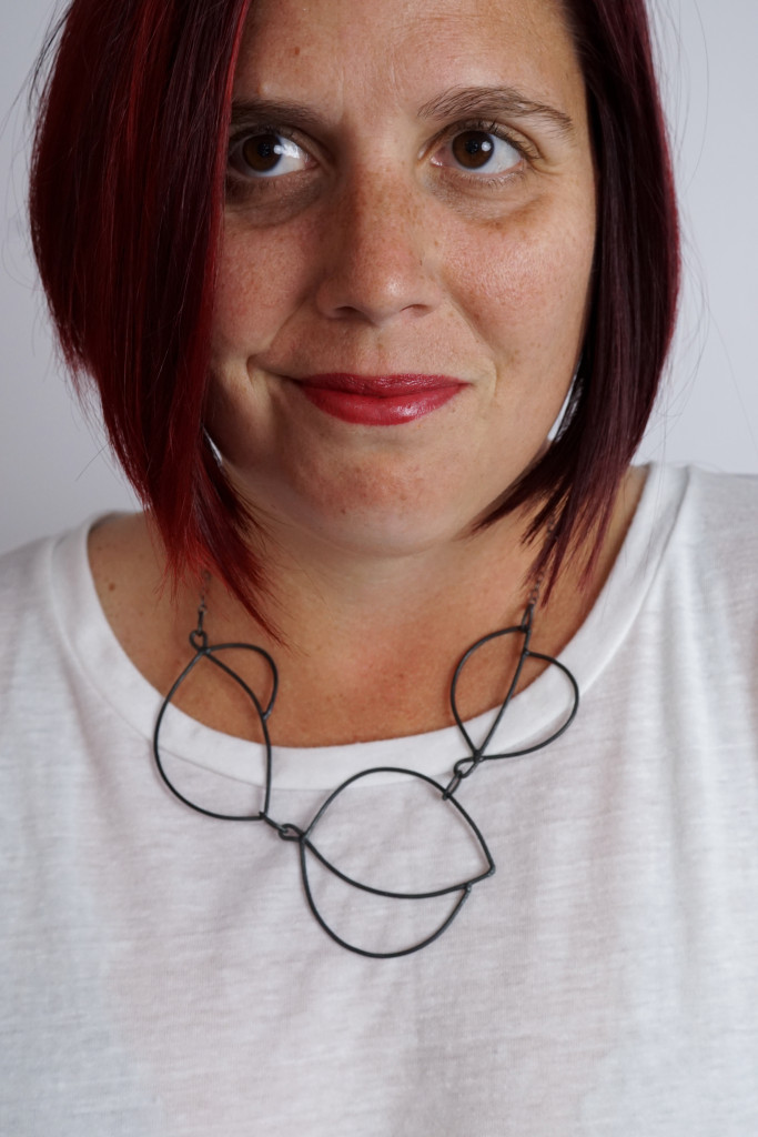 minimal art jewelry: modern graphic statement necklace on a white t-shirt