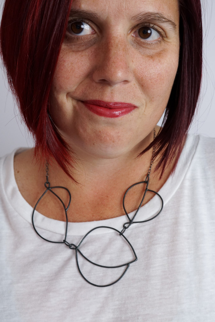 minimal art jewelry: modern graphic statement necklace on a white t-shirt