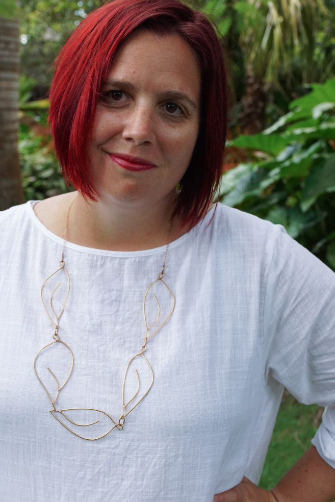 Matisse inspired statement necklace with white dress in tropical gardens