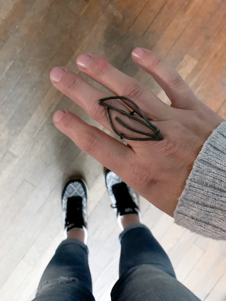 edgy style: cool black statement ring with jeans, sweater, and new balance sneakers