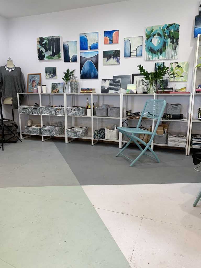 gallery wall in art studio with painted plywood floor