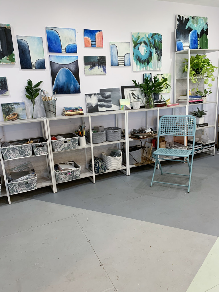 gallery wall in art studio with painted plywood floor