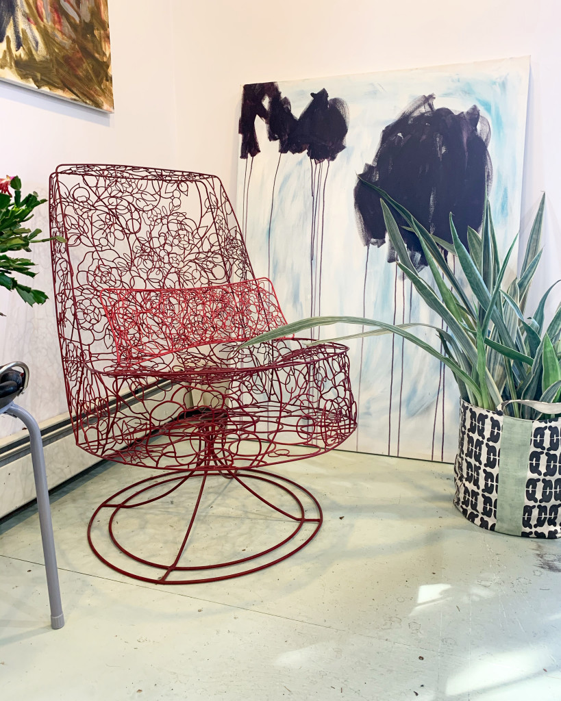 powdercoated wire chair and abstract paintings in the studio of artist and metalsmith megan auman