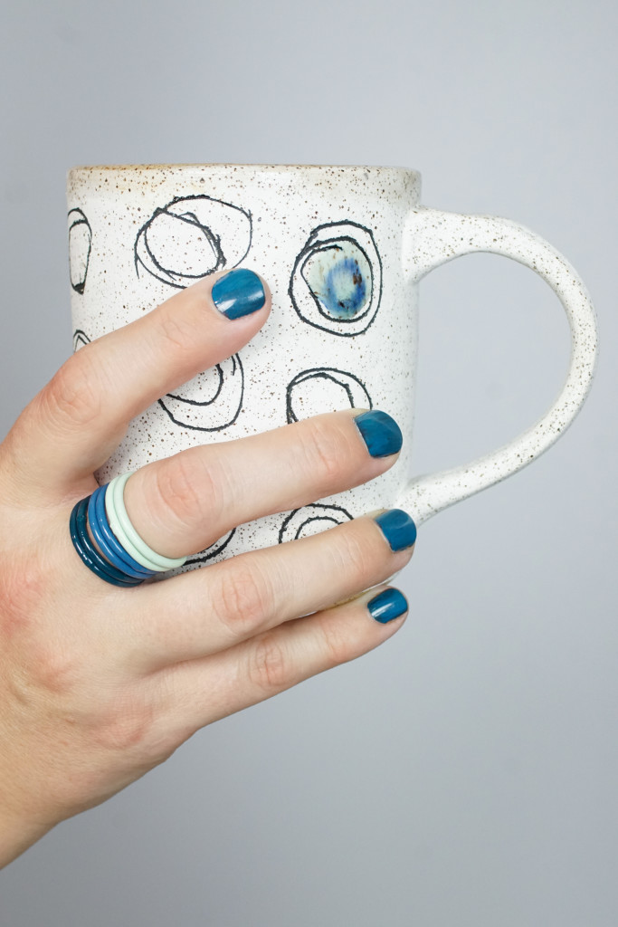 handmade ceramic mug and colorful stacking rings