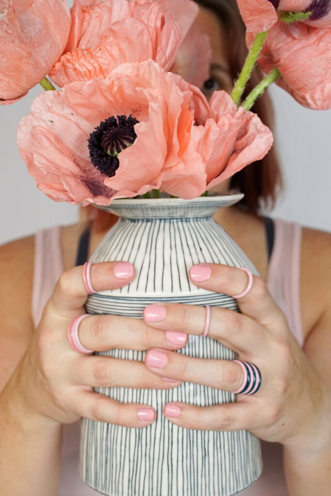 pink poppies in handmade ceramic vase with colorful stacking rings
