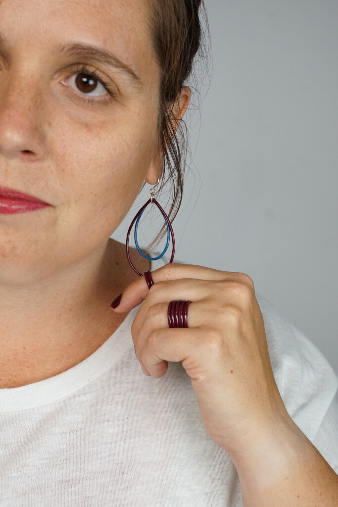 megan auman wearing burgundy jewelry in a nod to the burgundy suit Kamala Harris wore to speak at the DNC