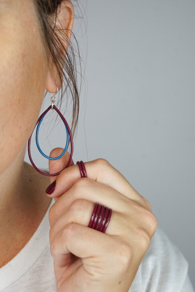 burgundy stacking rings and burgundy and blue earrings handmade by artist and metalsmith Megan Auman