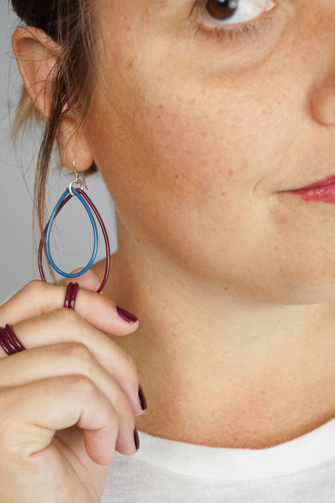 burgundy stacking rings and burgundy and blue earrings handmade by artist and metalsmith Megan Auman