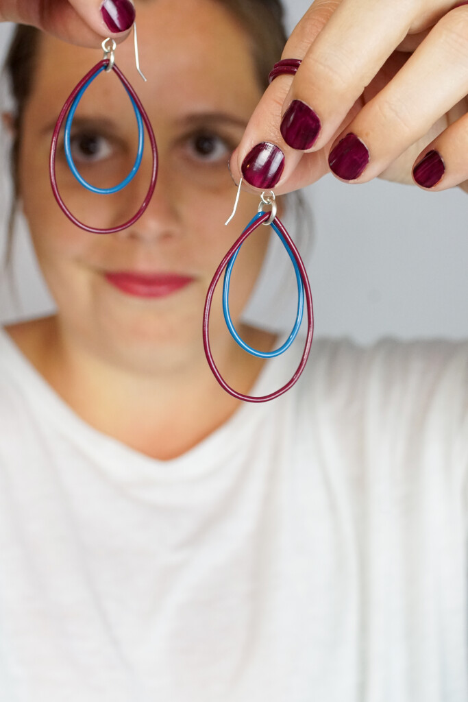 burgundy stacking rings and burgundy and blue earrings handmade by artist and metalsmith Megan Auman