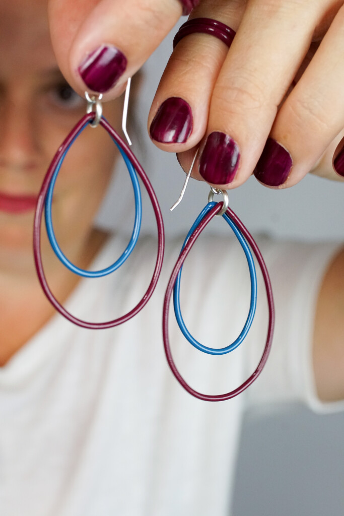 burgundy stacking rings and burgundy and blue earrings handmade by artist and metalsmith Megan Auman