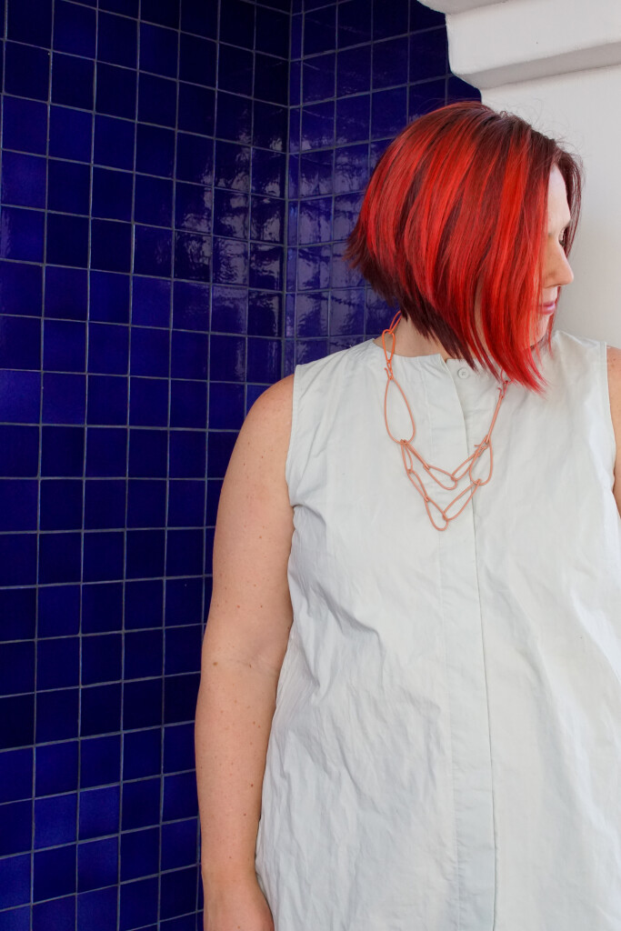 colorful statement necklace and blue tiled wall in Palm Springs