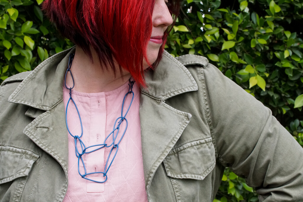 colorful statement necklace with dress and military jacket