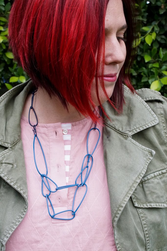 colorful statement necklace with dress and military jacket