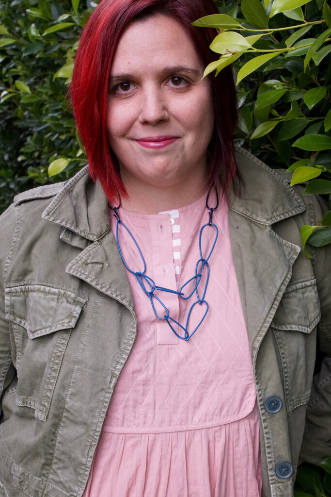 colorful statement necklace with dress and military jacket