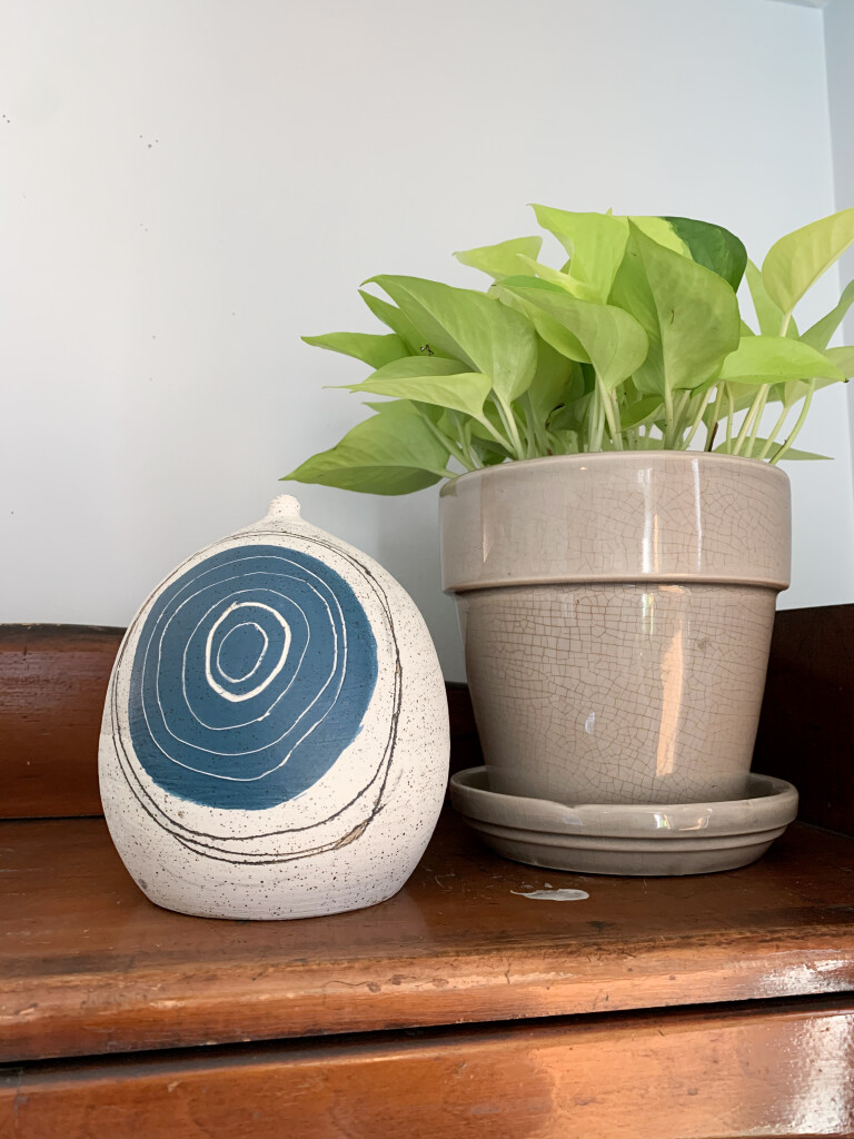 handmade ceramic orb and neon pothos plant