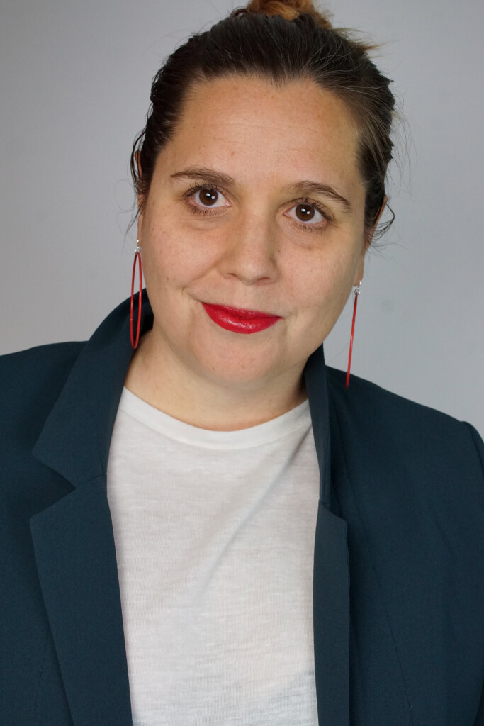 badass boss lady headshot inspiration: teal blazer, bold lip, red hoop earrings, top knot