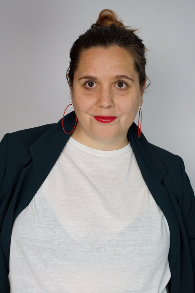 badass boss lady headshot inspiration: teal blazer, bold lip, red hoop earrings, top knot