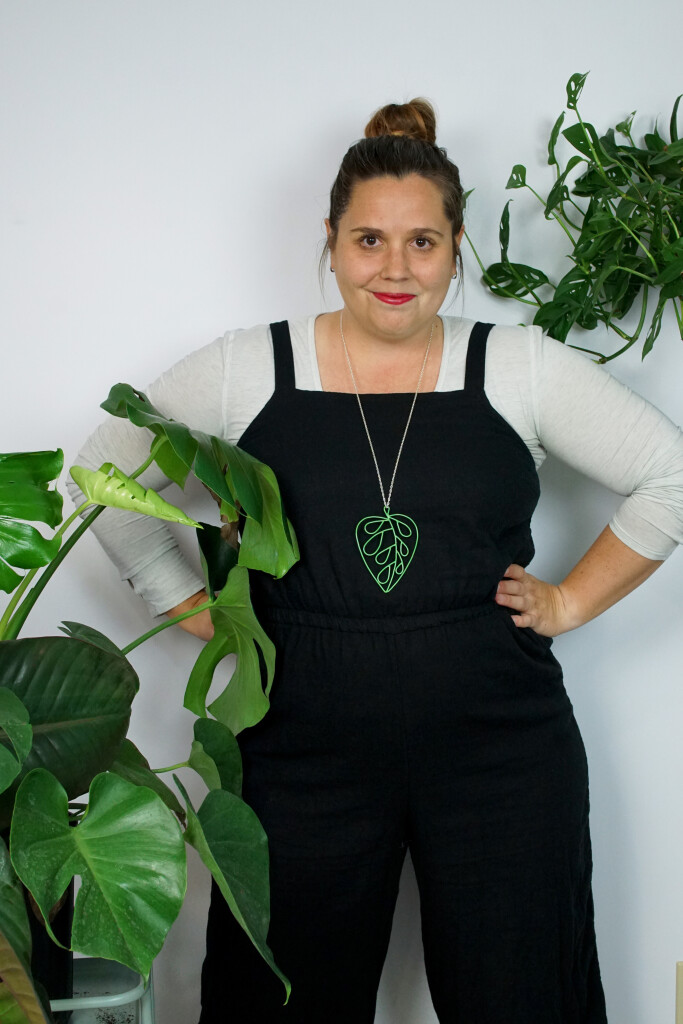 work from home style: black jumpsuit and plant inspired pendant