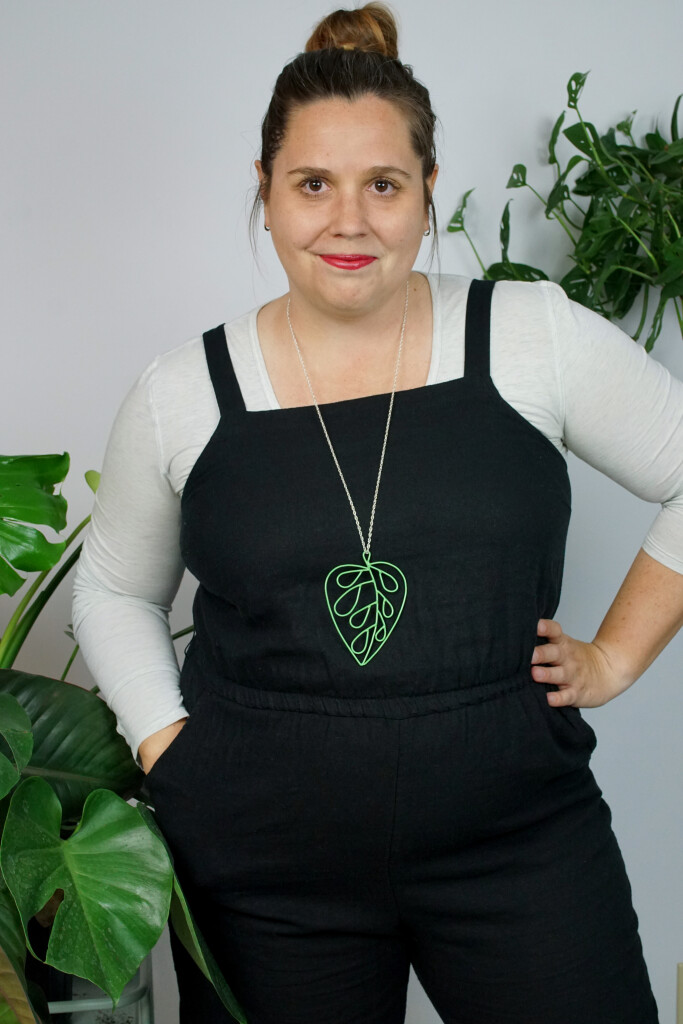 work from home style: black jumpsuit and plant inspired pendant