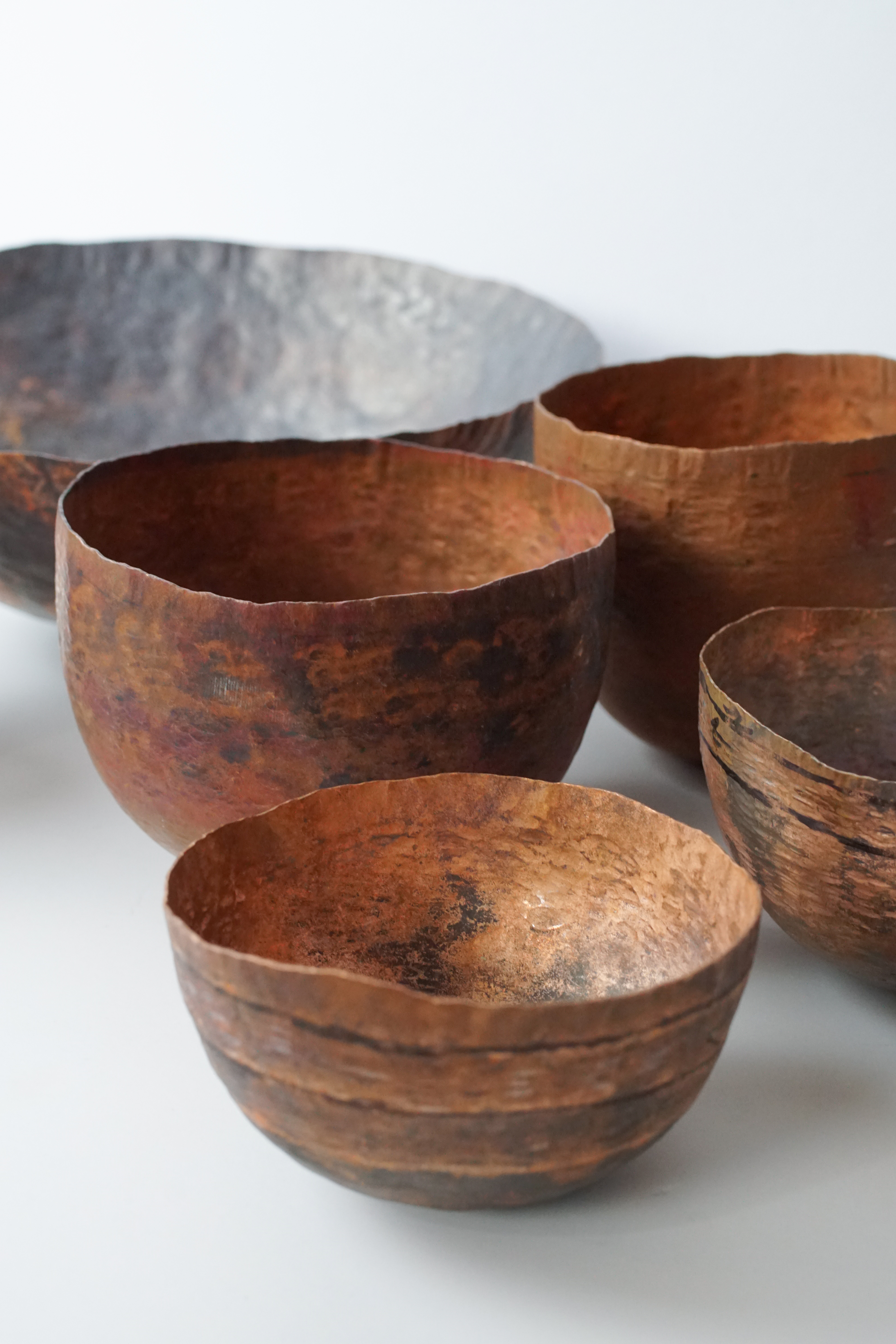 hammered copper bowls in progress