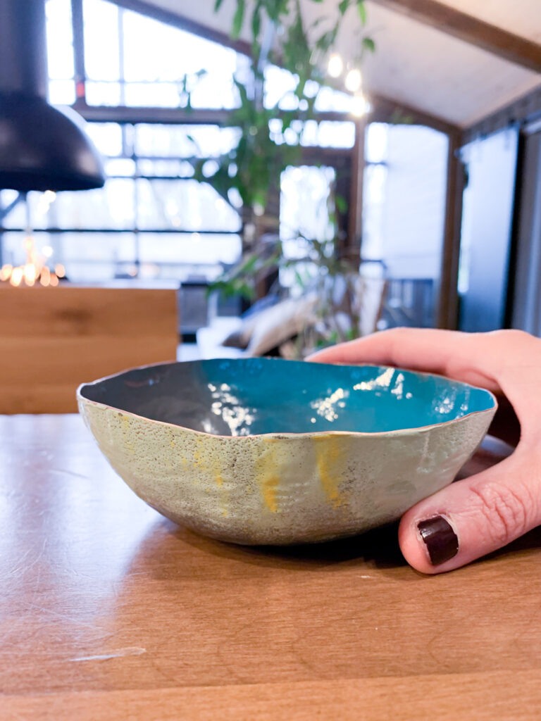colorful decorative copper bowl on the table at Dwellbox Treehouse Village