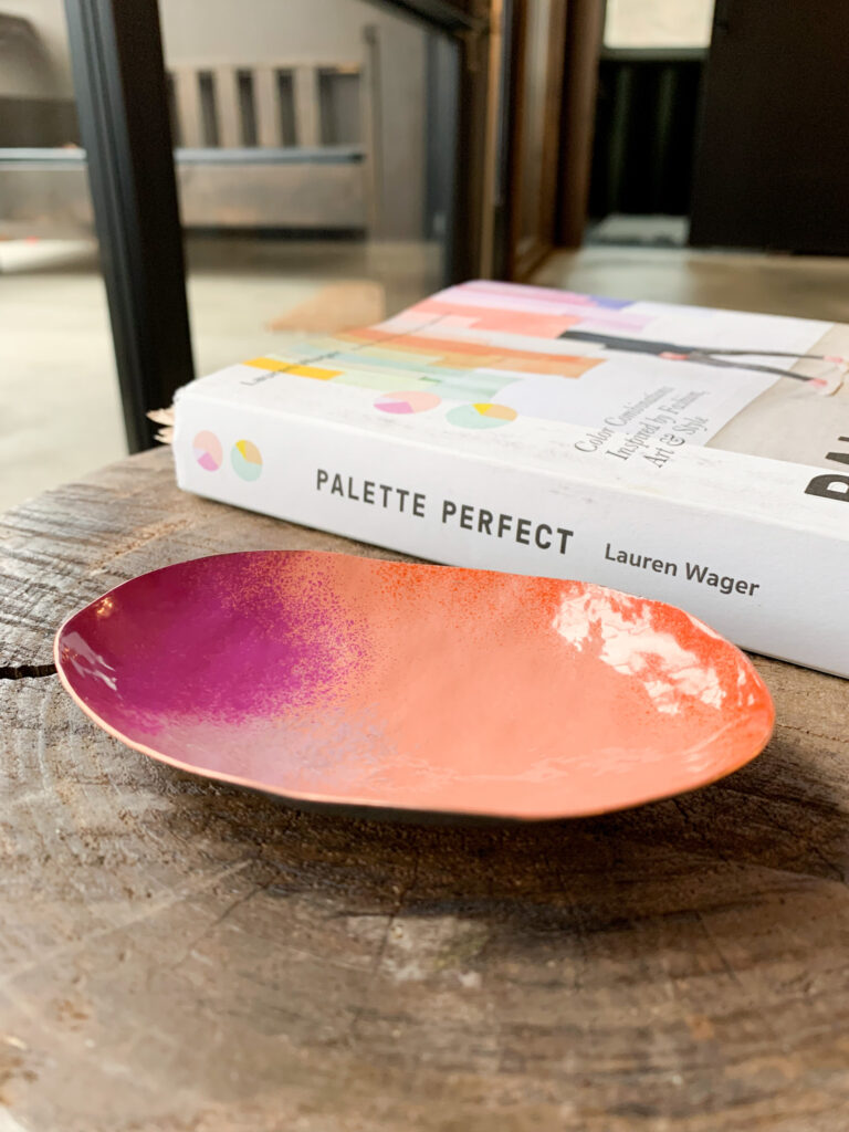 colorful decorative metal dish and books