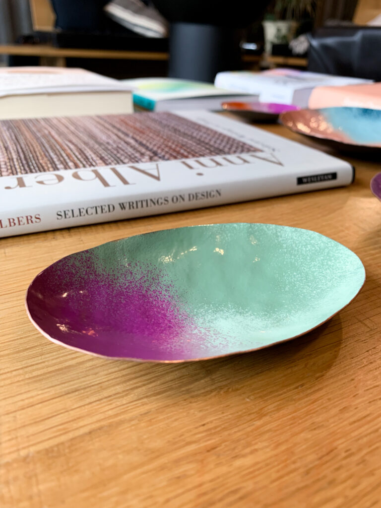 colorful decorative metal dish and books