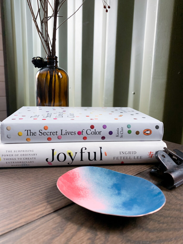 colorful decorative metal dish and books