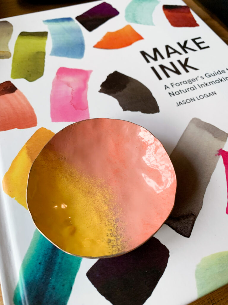 detail of Make Ink book and colorful decorative copper dish