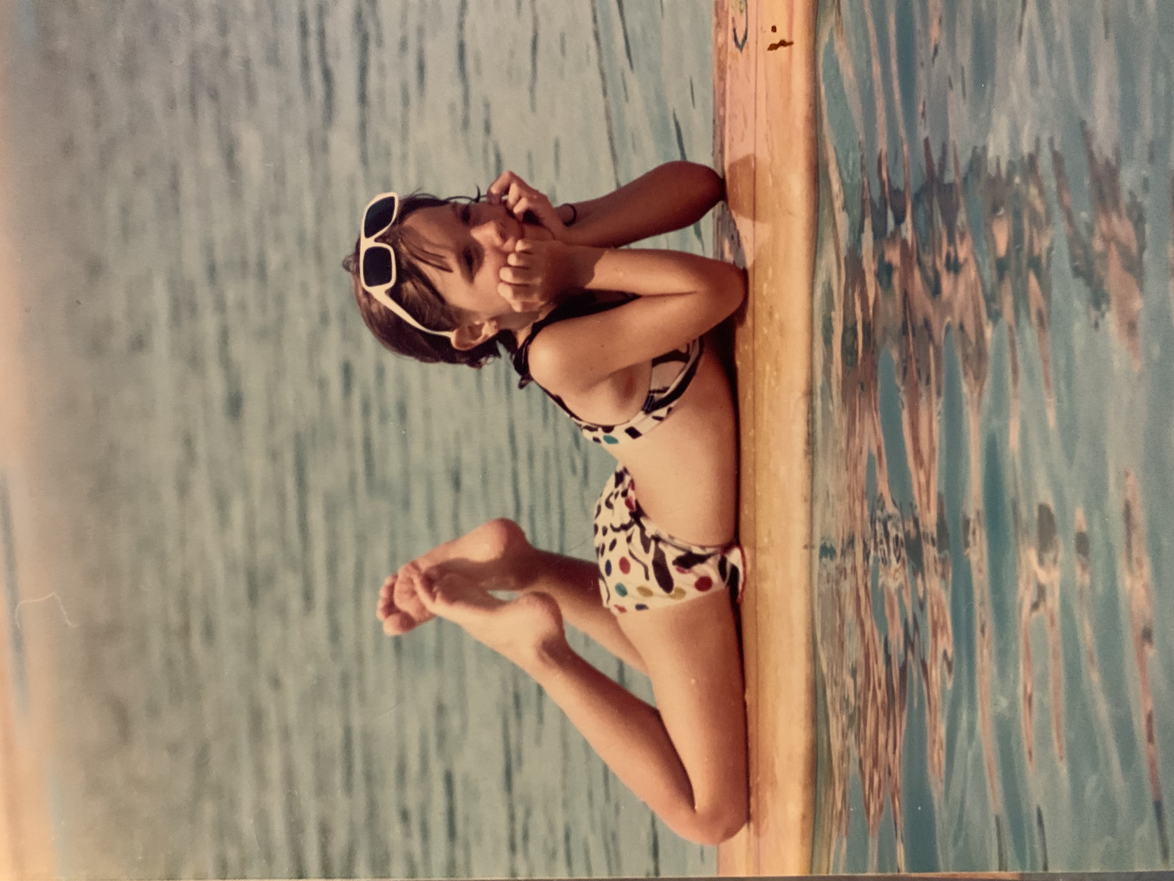 young Megan floating on surfboard in pool - vintage