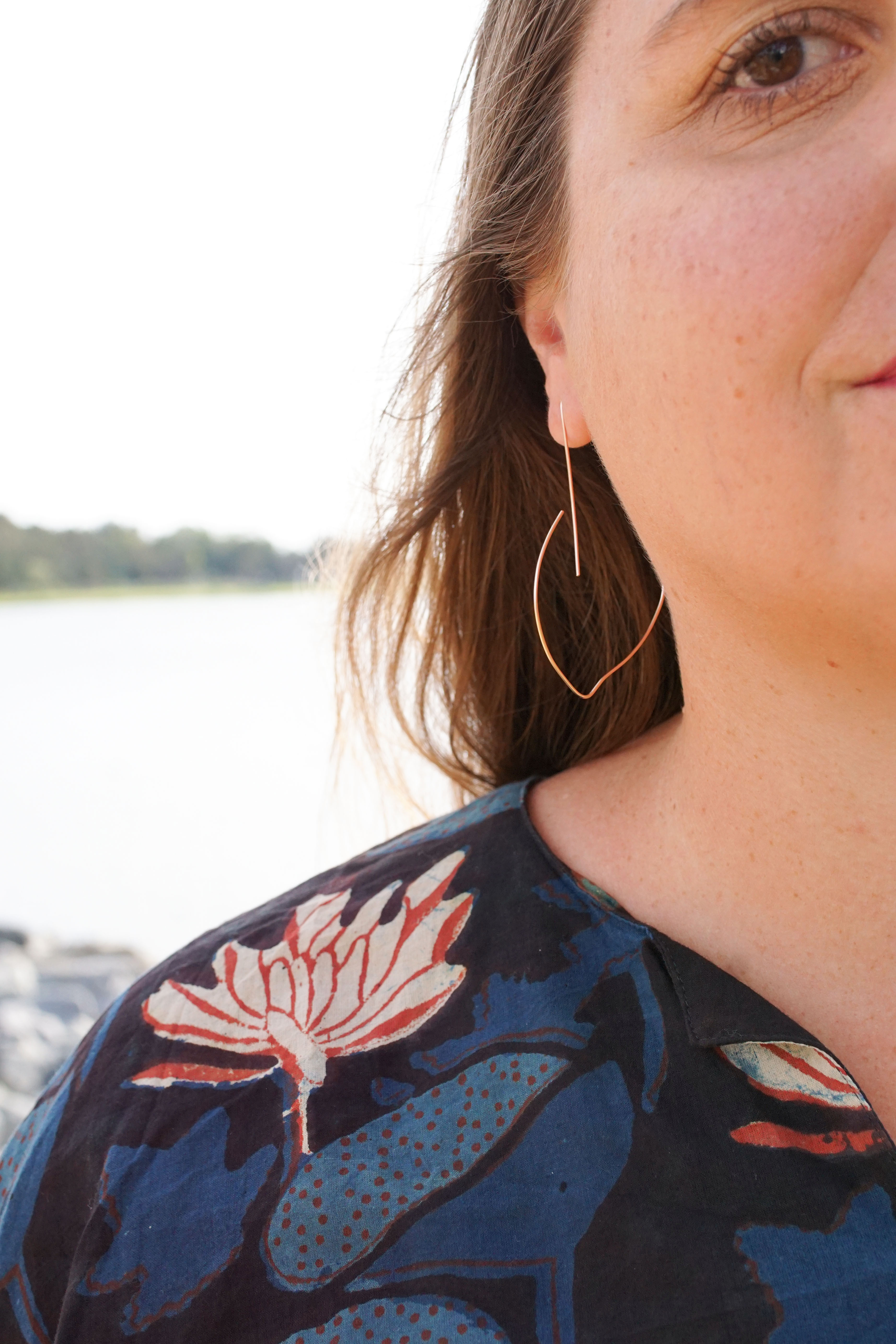 block-printed kaftan and rose gold threader hoop earrings at the beach