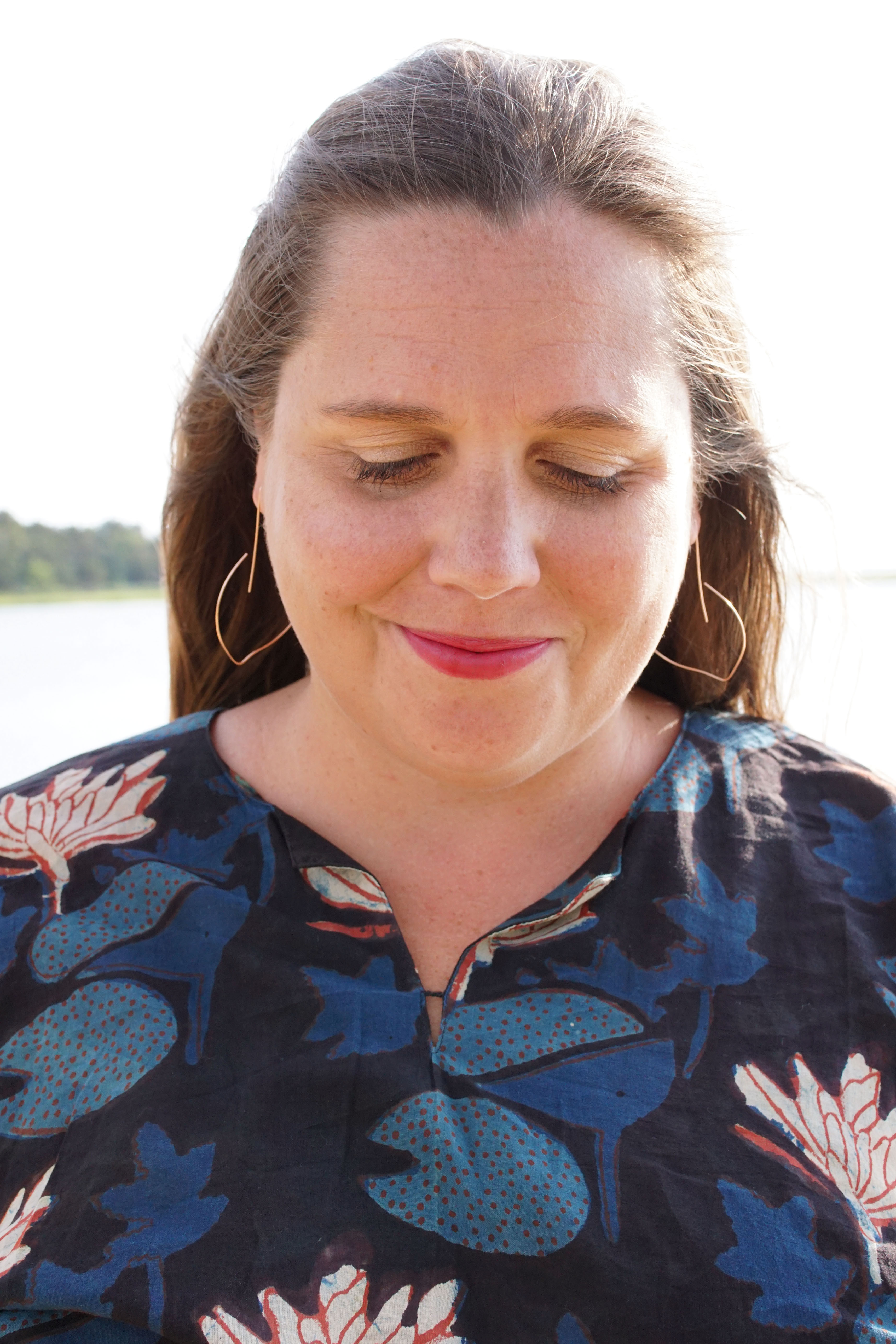 block-printed kaftan and rose gold threader hoop earrings at the beach