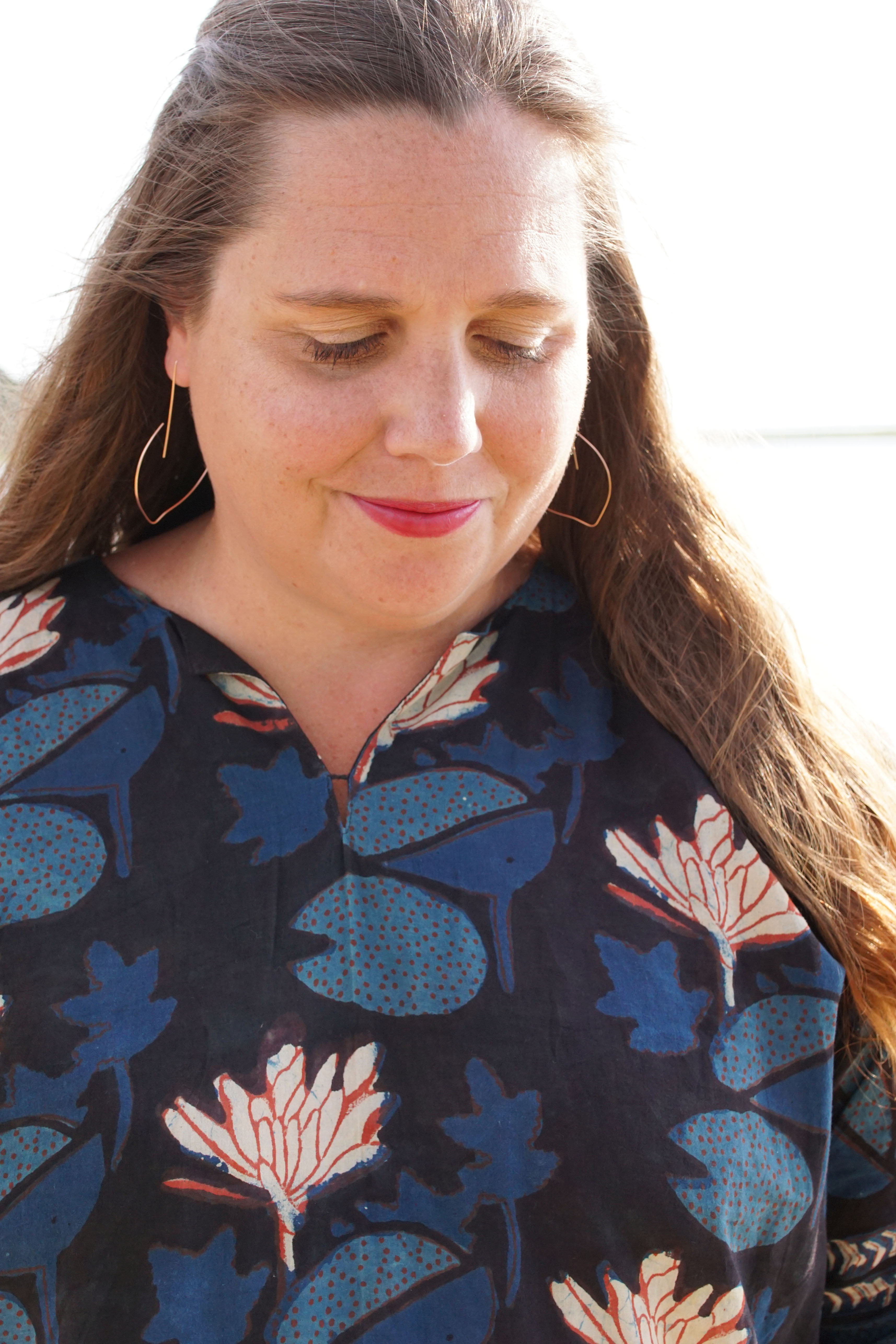 block-printed kaftan and rose gold threader hoop earrings at the beach