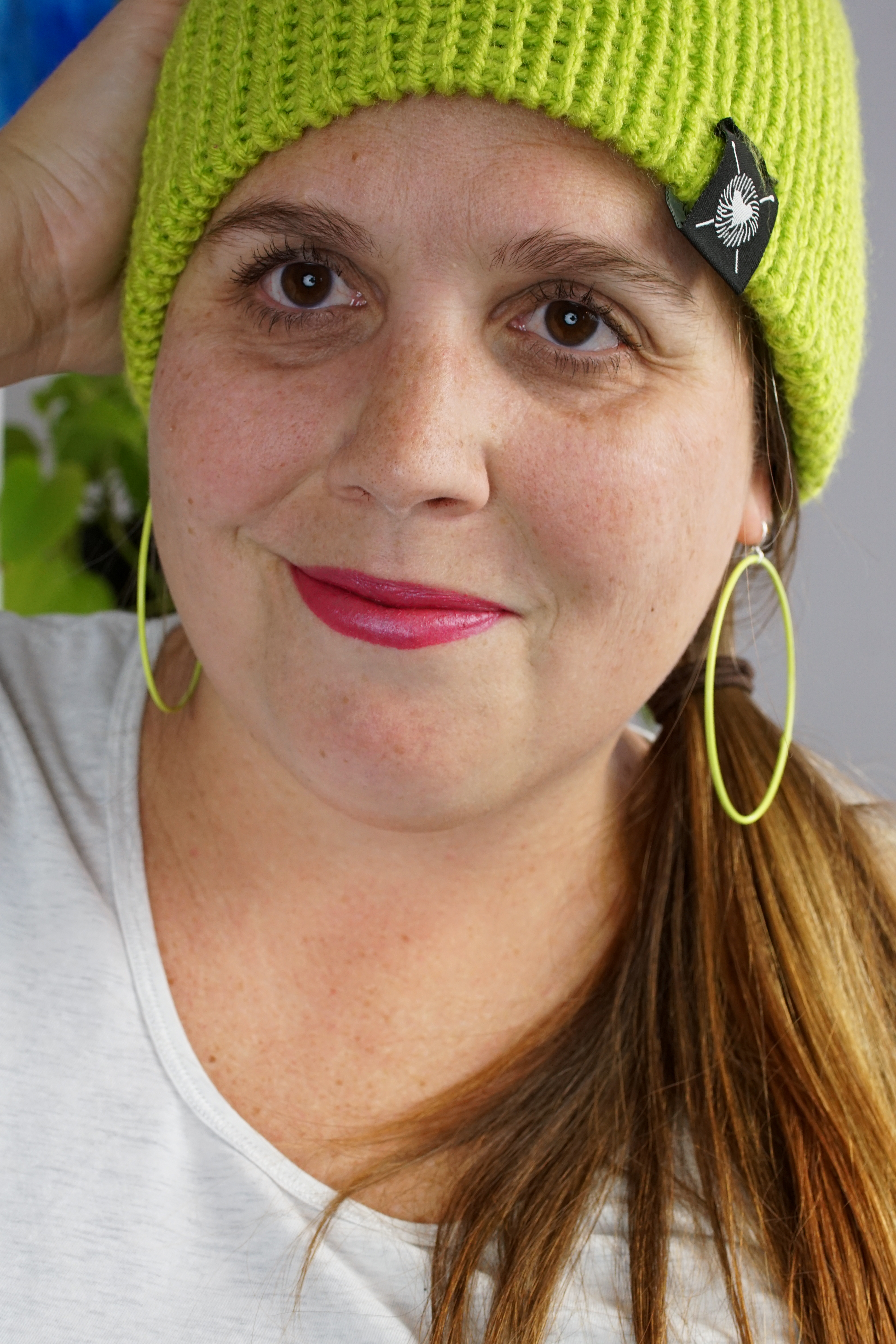 woman wearing neon knit hat and large neon hoop earrings