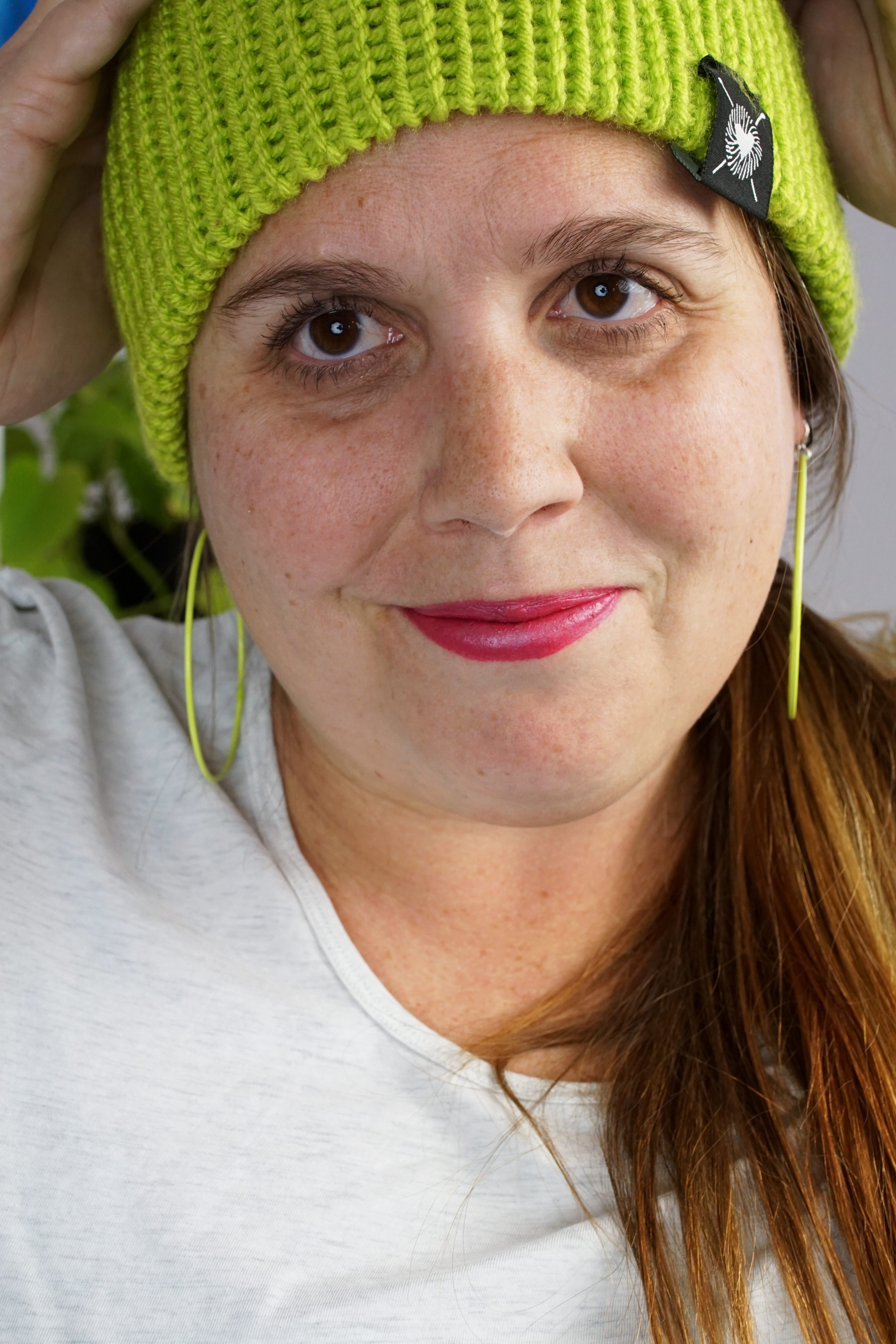 woman wearing neon knit hat and large neon hoop earrings