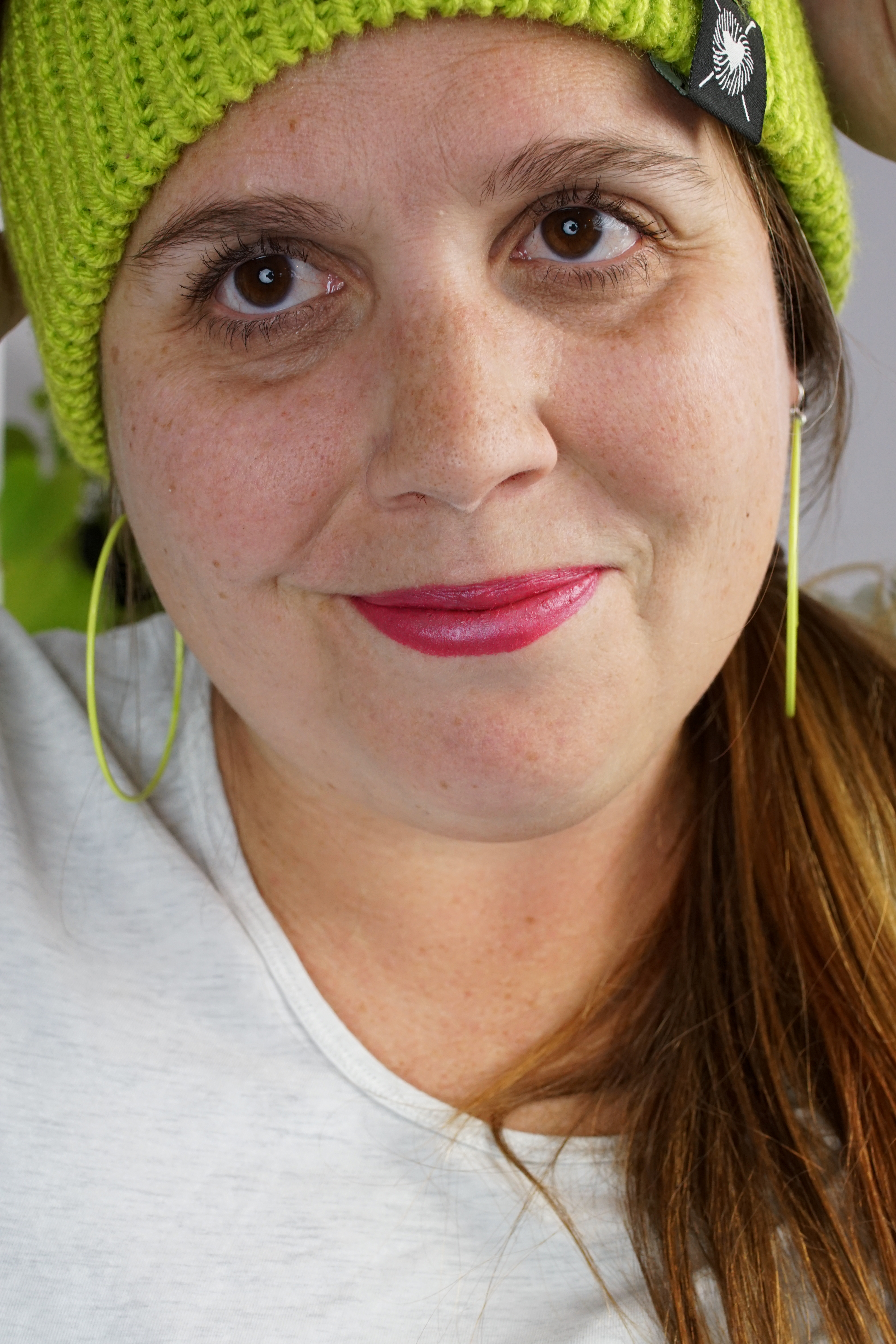 woman wearing neon knit hat and large neon hoop earrings