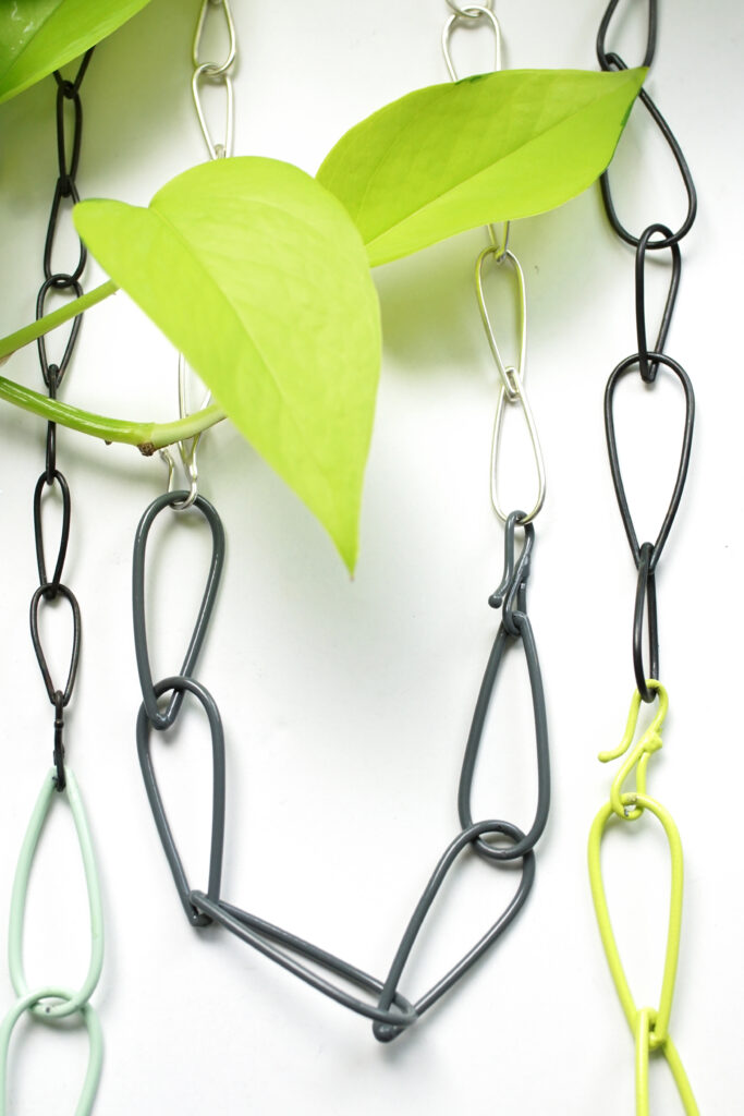 colorful and neon chain link necklaces with silver and steel and a neon pothos