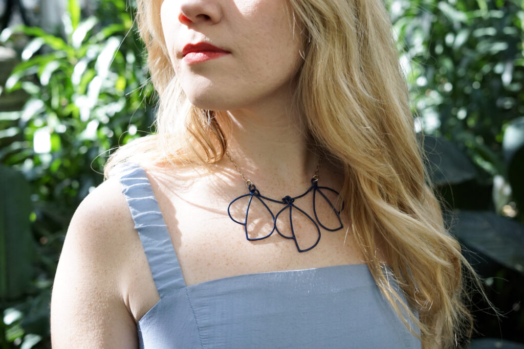 Trista in the garden with statement necklace