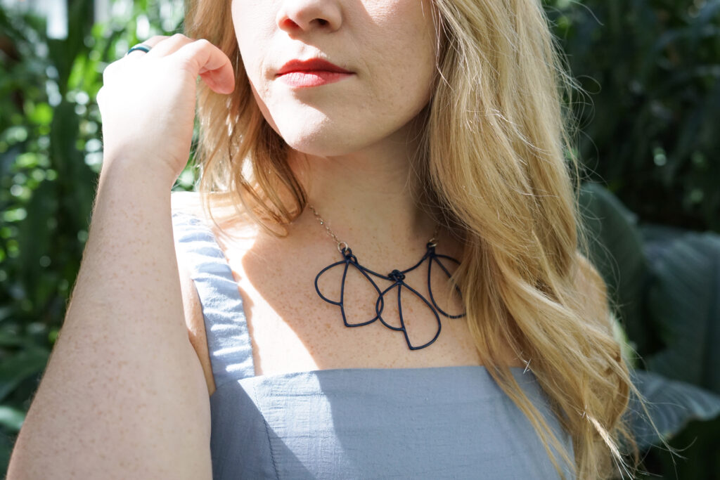 Trista in the garden with statement necklace