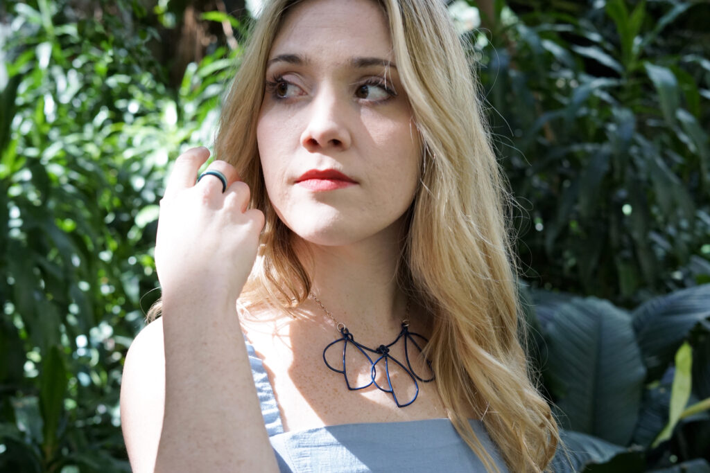 Trista in the garden with statement necklace