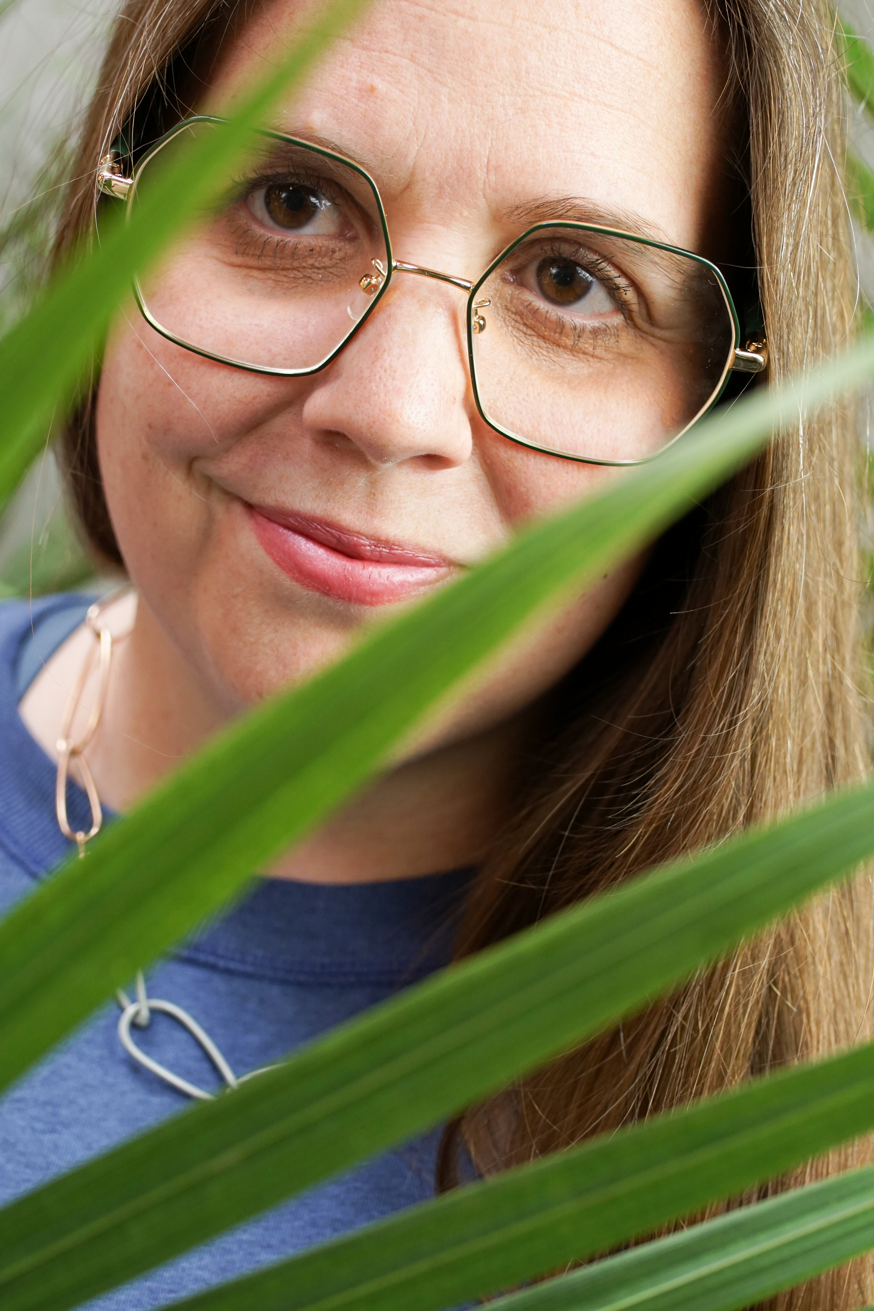 portrait with palm tree and chain link necklace with sweatshirt