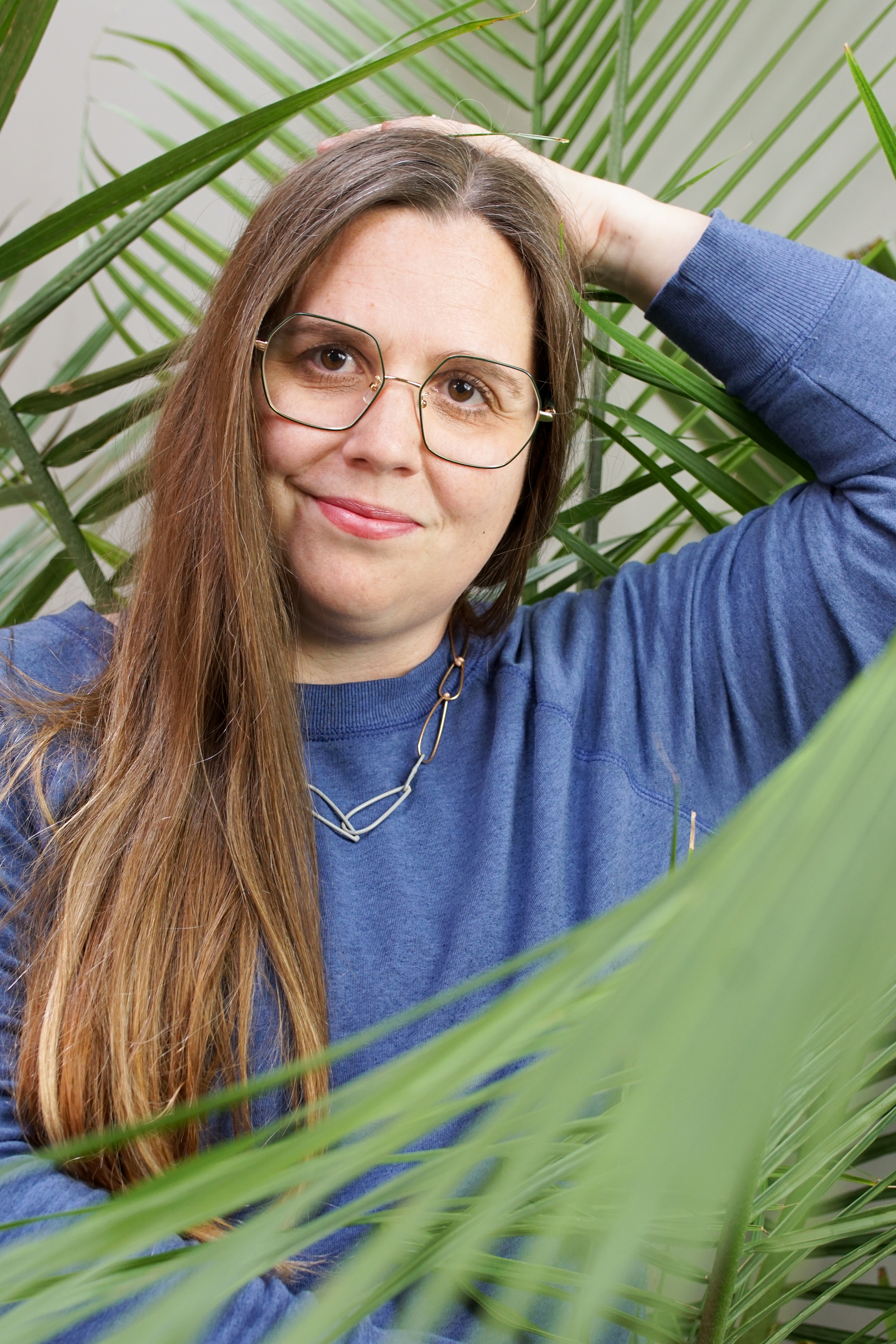 portrait with palm tree and chain link necklace with sweatshirt