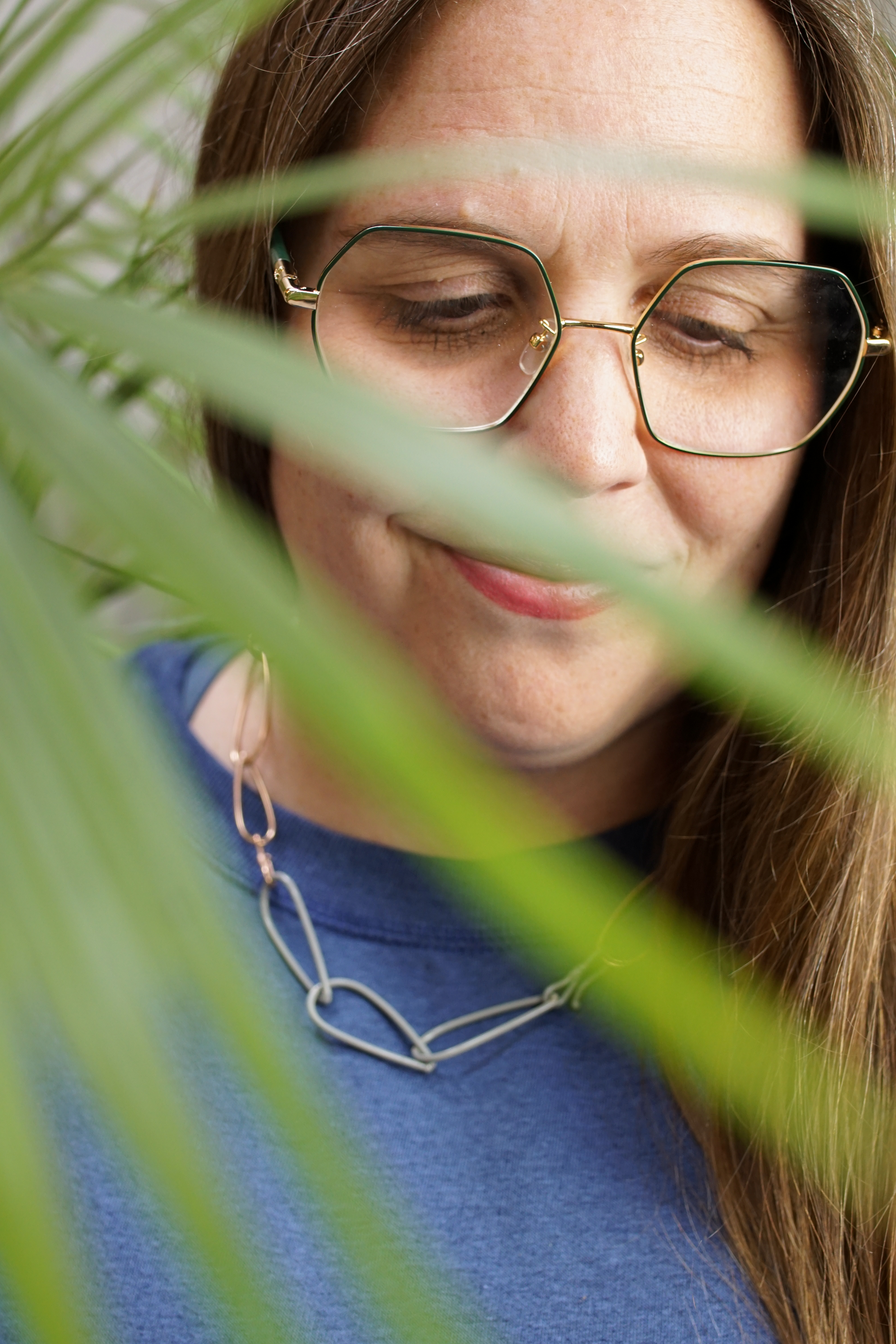 portrait with palm tree and chain link necklace with sweatshirt