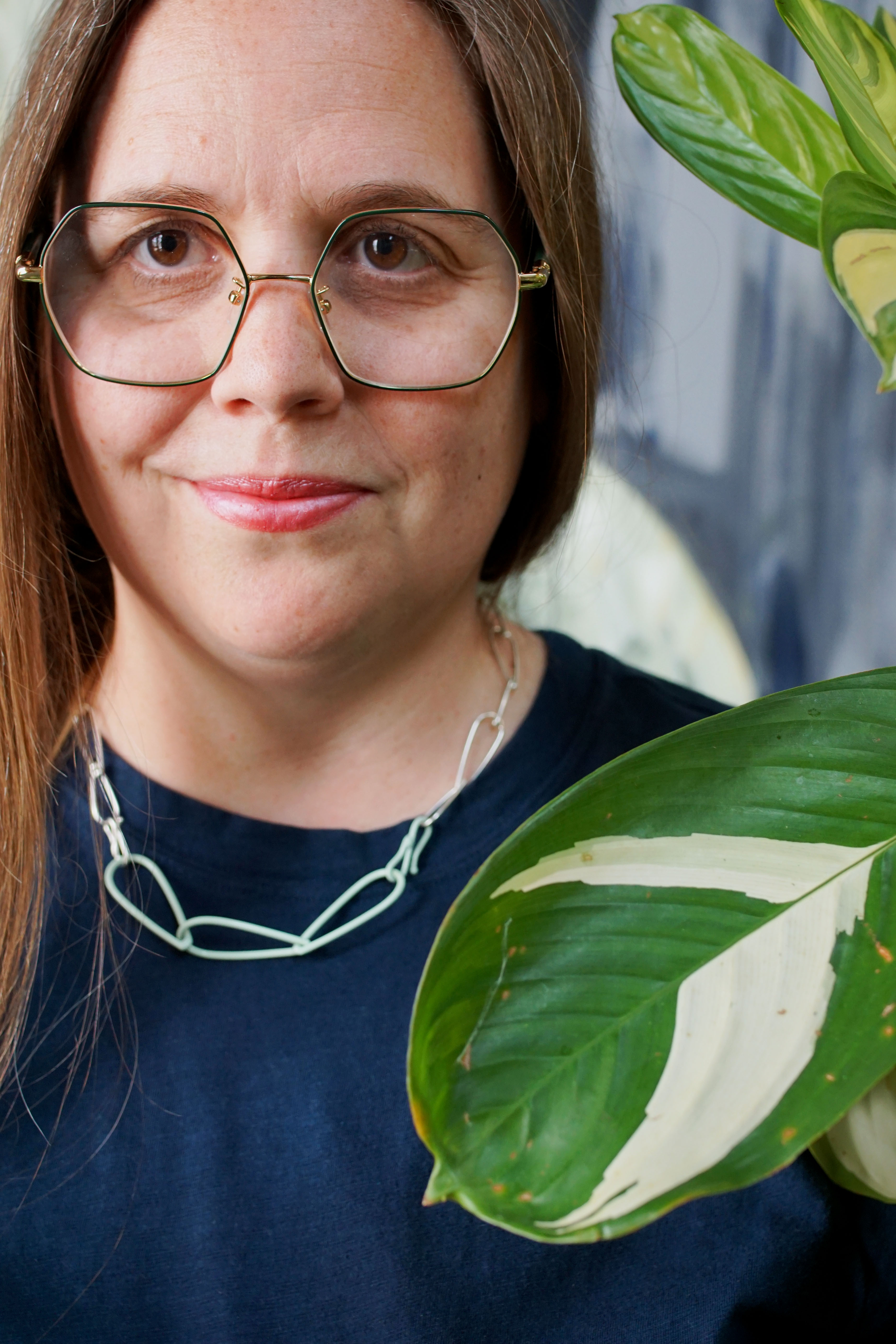 silver and mint necklace with dark teal t-shirt dress and plant