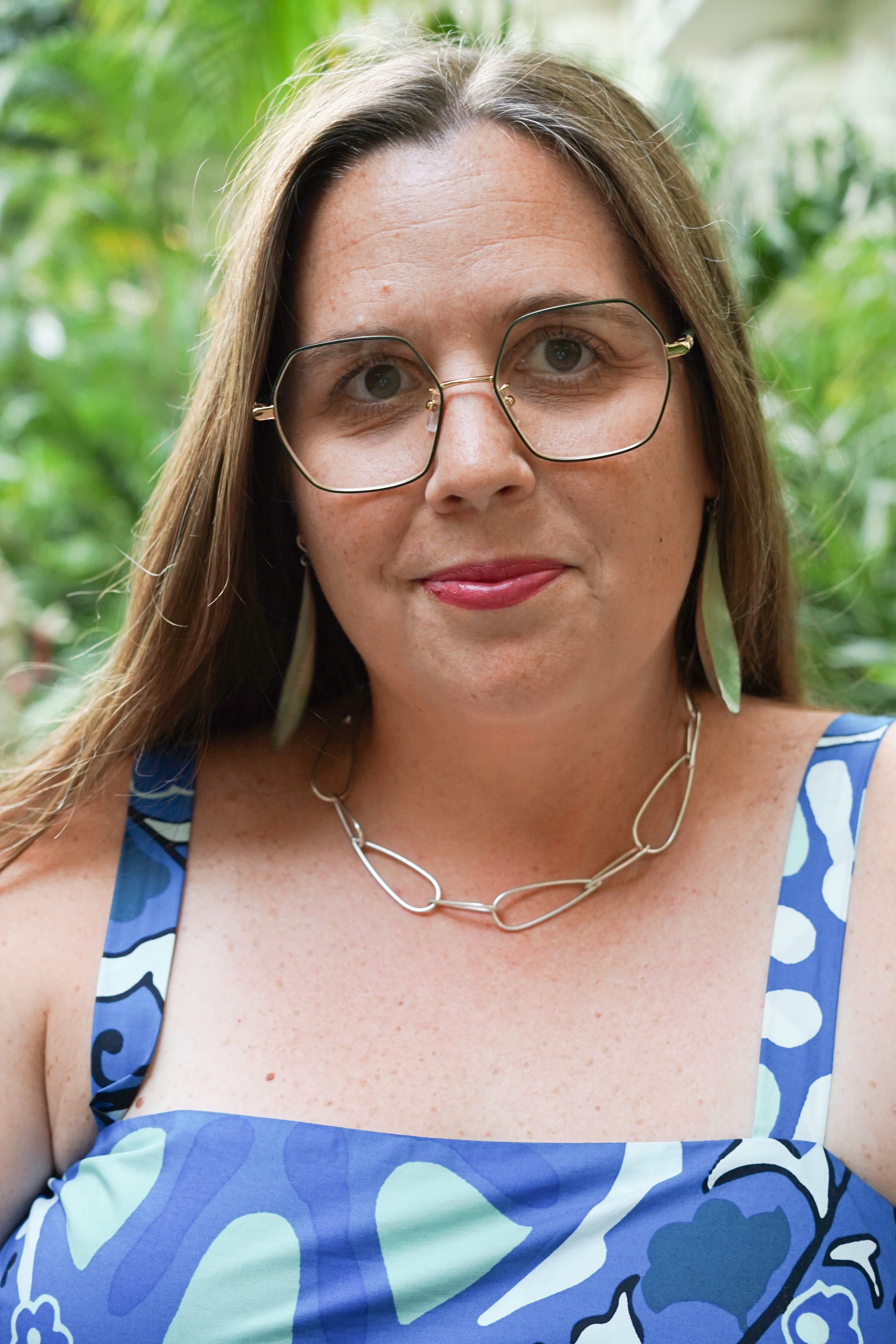 portraits with plants with statement earrings and chunky silver chain necklace