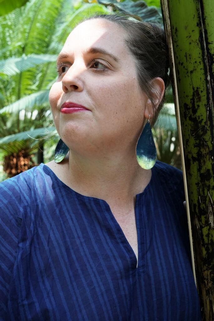 tropical vacation style: navy and neon statement earrings and navy kaftan