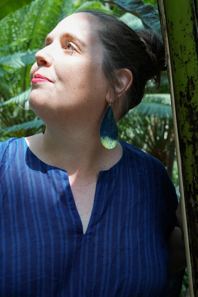 tropical vacation style: navy and neon statement earrings and navy kaftan